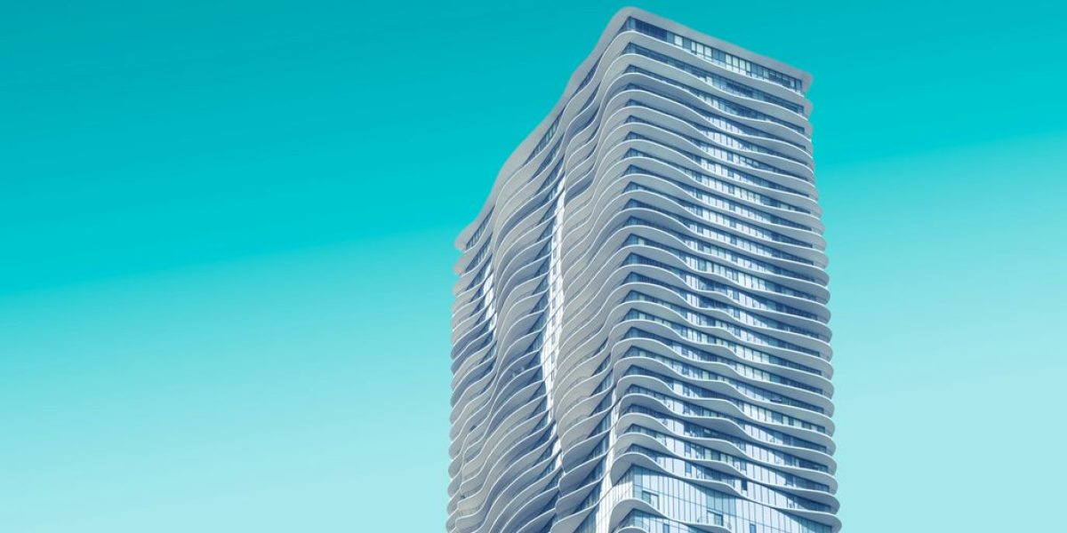 gray high rise building with teal background